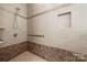 Nicely tiled shower with a grab bar and toiletry niche at 13216 Old Compton Ct, Pineville, NC 28134