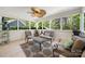 Bright sunroom with comfortable seating and a ceiling fan at 13216 Old Compton Ct, Pineville, NC 28134