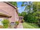 Brick home featuring a grilling area, screened porch, and wooded backyard at 1340 Piccadilly Dr, Charlotte, NC 28211