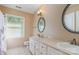 Bathroom featuring dual sinks, neutral walls and tile flooring at 1340 Piccadilly Dr, Charlotte, NC 28211
