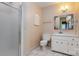 Updated bathroom with tiled floors, glass shower and white vanity at 1340 Piccadilly Dr, Charlotte, NC 28211