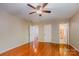 Bedroom with hardwood floors, ceiling fan and two entry doors at 1340 Piccadilly Dr, Charlotte, NC 28211