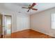 Bedroom with hardwood floors, closet, and entry door at 1340 Piccadilly Dr, Charlotte, NC 28211