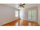 Well-lit bedroom with hardwood floors, a ceiling fan, and double doors at 1340 Piccadilly Dr, Charlotte, NC 28211