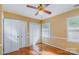 Cozy bedroom featuring hardwood floors, a ceiling fan, and ample closet space at 1340 Piccadilly Dr, Charlotte, NC 28211