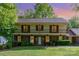 Charming two-story home with brick facade, large front yard, and covered second-story balcony at 1340 Piccadilly Dr, Charlotte, NC 28211