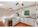 Spacious kitchen featuring white cabinets, granite countertops, wine cooler and hardwood floors at 1340 Piccadilly Dr, Charlotte, NC 28211