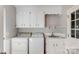 Well-equipped laundry room with washer, dryer, sink and ample storage at 1340 Piccadilly Dr, Charlotte, NC 28211