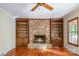 Cozy living room with a stone fireplace, built-in shelves, and hardwood floors at 1340 Piccadilly Dr, Charlotte, NC 28211
