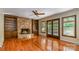Inviting living room with stone fireplace, hardwood floors, built-in shelves and access to the deck at 1340 Piccadilly Dr, Charlotte, NC 28211