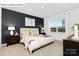 This primary bedroom features a large window, a decorative wall, and soft, neutral colors at 1352 Secrest Commons Dr, Monroe, NC 28112