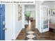 Inviting hallway with hardwood floors leading to a living room and French doors at 1356 Secrest Commons Dr, Monroe, NC 28112