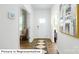 Hallway with hardwood floors and white trim, leading to a bright living space at 1356 Secrest Commons Dr, Monroe, NC 28112