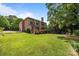 Expansive backyard featuring a deck and lush landscaping under a clear blue sky at 18305 Dembridge Dr, Davidson, NC 28036