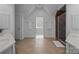 A luxurious bathroom with a walk-in shower, a double vanity, and white tiling at 18305 Dembridge Dr, Davidson, NC 28036