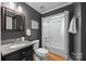 Well-lit bathroom featuring granite countertops and a shower-tub combo at 18305 Dembridge Dr, Davidson, NC 28036