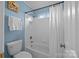 Bathroom featuring a tub, shower, toilet, towel, and blue painted walls at 18305 Dembridge Dr, Davidson, NC 28036