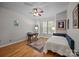 Cozy bedroom with hardwood floors, a ceiling fan, and a large window at 18305 Dembridge Dr, Davidson, NC 28036