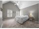 A bright bedroom featuring a high ceiling, plush carpeting, and abundant natural light at 18305 Dembridge Dr, Davidson, NC 28036