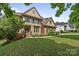 Elegant two-story home featuring a manicured lawn and beautiful landscaping at 18305 Dembridge Dr, Davidson, NC 28036
