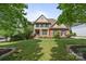 Charming brick home with manicured lawn and mature trees offers classic suburban living at 18305 Dembridge Dr, Davidson, NC 28036