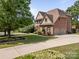 Two-story brick home with an attached two car garage and landscaped front yard at 18305 Dembridge Dr, Davidson, NC 28036