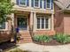 Inviting entryway with a blue door and brick steps at 18305 Dembridge Dr, Davidson, NC 28036