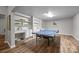 Bright game room with built-in shelves and cabinets, and a ping pong table at 18305 Dembridge Dr, Davidson, NC 28036