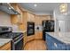 Modern kitchen with stainless steel appliances, granite countertops, and wooden cabinets at 18305 Dembridge Dr, Davidson, NC 28036