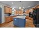 Stylish kitchen featuring wooden cabinetry, granite countertops, and stainless steel appliances at 18305 Dembridge Dr, Davidson, NC 28036