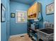 A functional laundry room featuring storage cabinets and a stainless steel sink at 18305 Dembridge Dr, Davidson, NC 28036