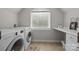 Modern laundry room with appliances and a workspace, offering convenience and functionality at 18305 Dembridge Dr, Davidson, NC 28036