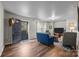 Living room with wood floors, a blue couch, and a view of the outside at 18305 Dembridge Dr, Davidson, NC 28036