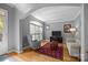 Comfortable living room with hardwood floors, a sofa, accent chair and large window at 18305 Dembridge Dr, Davidson, NC 28036