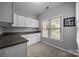 Bright office space with a large window, neutral carpet, and built-in cabinets with plenty of storage space at 18305 Dembridge Dr, Davidson, NC 28036