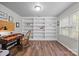 Spacious office with built-in shelving, desk, and natural light from the window at 18305 Dembridge Dr, Davidson, NC 28036