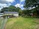 Expansive backyard with lush green grass and mature trees, providing ample space at 201 Mitchell St, Belmont, NC 28012