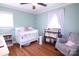 Light-filled bedroom with hardwood floors and a crib at 201 Mitchell St, Belmont, NC 28012