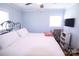 Bedroom with two windows, a metal bed frame, ceiling fan, and wood floors at 201 Mitchell St, Belmont, NC 28012