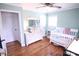 Bright Bedroom with a white crib, dresser, ceiling fan and lovely natural light at 201 Mitchell St, Belmont, NC 28012