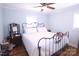 Cozy bedroom features a metal bed frame, hardwood floors and a ceiling fan at 201 Mitchell St, Belmont, NC 28012