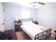 Well-lit bedroom with a metal bed frame, ceiling fan, natural light and wood floors at 201 Mitchell St, Belmont, NC 28012