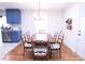 Cozy dining room featuring hardwood floors and a large wooden table adjacent to a modern, well-equipped kitchen at 201 Mitchell St, Belmont, NC 28012