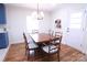 Bright dining room with hardwood floors and a classic wood table, perfect for Gathering meals and gatherings at 201 Mitchell St, Belmont, NC 28012