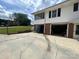 Rear exterior featuring a garage, screened porch, and a spacious paved driveway at 201 Mitchell St, Belmont, NC 28012