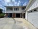 Back exterior with garage, screened porch, and extra storage with large driveway at 201 Mitchell St, Belmont, NC 28012