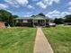 Front exterior view of home with green lawn, walkway, and covered front porch at 201 Mitchell St, Belmont, NC 28012