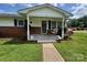 Inviting front porch with a classic swing, offering a relaxing outdoor space at the entrance of the home at 201 Mitchell St, Belmont, NC 28012