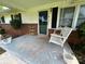 Inviting front porch with a charming white porch swing and brick accents at 201 Mitchell St, Belmont, NC 28012