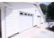 White garage with a concrete driveway and two white garage doors at 201 Mitchell St, Belmont, NC 28012